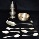 A COLLECTION OF SILVER comprising a sugar sifter, bowl and an assortment of spoons, weight