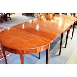 MAHOGANY D END DINING TABLE raised on tapering legs and having a central drop flap section,