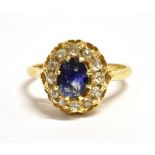 AN 18CT GOLD SAPPHIRE AND DIAMOND CLUSTER RING the oval facetted sapphire measuring 0.7cm by 0.5cm