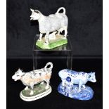 TWO COW CREAMERS WITH SPONGED DECORATION, and another with blue painted decoration, the tallest 15cm