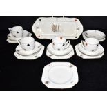 A CARLTON WARE PART TEA SERVICE decorated with playing cards, comprising four cups, five saucers and