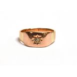 A 9CT GOLD STAR SET DIAMOND SIGNET RING with faded markings to the shank, ring size N, weight