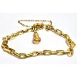 A MARKED 750 YELLOW MEATAL TWISTED CURB CHAIN BRACELET With a single marked 375 gold charm attached,