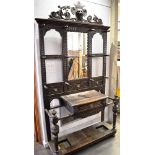 AN EDWARDIAN CARVED OAK HALLSTAND with central mirrored section, H 242cm x W 144cm x D 40cm
