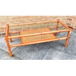 A G-PLAN FAUX BAMBOO COFFEE TABLE with glass inset top and caned undertier, 53cm x 122cm, 46cm