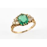 AN EMERALD AND OLD CUT DIAMOND RING The faceted oval Emerald measuring approx. 8mm by 6 mm and