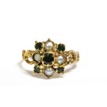 A SEED PEARL AND EMERALD PASTE FLOWER HEAD RING The flower head measuring 1cm by 1cm and set with