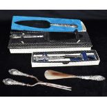 THREE BOXED SILVER HANDLED KNIVES comprising two cake slices and a cheese knife, together with