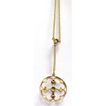A 9CT GOLD EDWARDIAN PENDANT AND CHAIN the circular openwork drop pendant set with peridots and seed