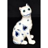 A FRENCH FAIENCE FIGURE OF A SEATED CAT, with blue glass eyes, probably Mosanic, impressed 1889 to