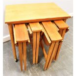 A NEST OF TABLES IN THE MANNER OF POUL HUNDEVAD the largest table 62cn x 42cm, with four drop-leaf