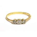 AN 18CT GOLD PLATINUM AND DIAMOND THREE STONE ILLUSION SET RING marked 18ct and plat to the shank,