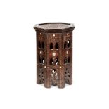A MOORISH OCTAGONAL OCCASIONAL TABLE inlaid with mother-of-pearl, and carved with kufic script, 32.