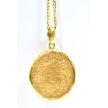 A GOLD SWISS 20 FRANC COIN DATED 1935 Mounted in 9ct gold and suspended on a 9ct gold chain pendant,