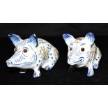 A PAIR OF FRENCH FAIENCE FIGURAL QUILL HOLDERS modelled as seated pigs, with polychrome enamelled
