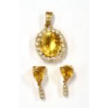 A YELLOW SPESSARITE GARNET AND CRYSTAL PASTE PENDANT AND EARRINGS DEMI-PARURE The pendant and