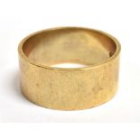 A 9CT GOLD WIDE BAND RING Hallmarked for London 1977, ring size T, 0.9cm wide, weight 6.3g.