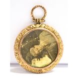 AN EARLY 20th CENTURY REVERSE PHOTO LOCKET/FOB The circular locket mounted in rose and yellow