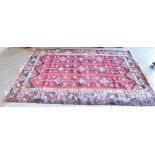 A LARGE RED GROUND RUG 197cm x 276cm Condition Report : poor condition - the pile is thick, but