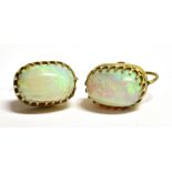 A PAIR OF VINTAGE 9CT GOLD OPAL SCREW ON CLIP EARRINGS The opals measuring 1.3cm by 0.8cm, marked