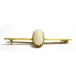 A LATE VICTORIAN 9CT GOLD OPAL BAR BROOCH The pinfire opal measuring 1.4cm by 0.8cm, centrally set