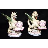 A PAIR OF FRENCH FAIENCE CANDLESTICKS modelled as gryphons, with enamelled and gilded decoration,