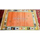 A CONTEMPORARY HANDWOVEN RUG with rust ground central field, the border decorated with stylised