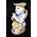 A FRENCH FAIENCE TOBY JUG with polychrome painted and sponged decoration, 24cm high Condition Report