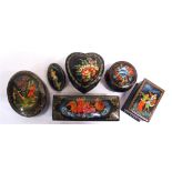 FIVE RUSSIAN LACQUERED BOXES each with a hand-painted design, including a troika, the largest 10.5cm