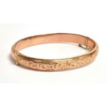 A VINTAGE 9CT ROSE GOLD HALF PATTERNED BANGLE The bangle fitted with a safety chain and hallmarked