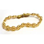 A YELLOW METAL BRACELET OF DOUBLE ROW FANCY OPEN WORK CIRCLES Fitted with a push clasp, bracelet