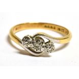 AN 18CT GOLD, PLATINUM AND TRIPLE DIAMOND SET CROSS OVER RING The ring marked 18ct Plat H.G.&S, ring