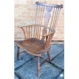 AN ASH, ELM AND BEECH WINDSOR ARMCHAIR with shaped splat back, on rign turned supports with H-shaped