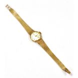 A LADIES 9CT GOLD OMEGA BRACELET WATCH With champagne dial and gilt batons and indexes fitted with a