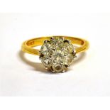 AN 18CT GOLD, CLEAR CRYSTAL PASTE FOWER HEAD RING The flower head measuring approx. 1cm in diameter,