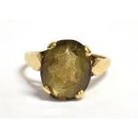 A 9CT GOLD BROWN TOURMALINE COCKTAIL RING The oval faceted stone measuring 1.3cm x 1cm, the shank