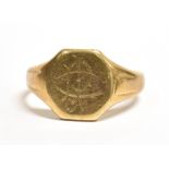 A 9CT GOLD SIGNET RING The ring with engraved initial to the hexagon shaped bezel, grooved shoulders