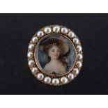 A GEORGIAN PORTRAIT MINIATURE RING The glass fronted miniature featuring a portrait of a young