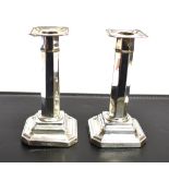 A PAIR OF WEIGHTED EDWARDIAN SILVER CANDLESTICKS Of geometric design, hallmarked for Sheffield 1905,