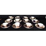 TWELVE EARLY 20TH CENTURY MEISSEN CABINET CUPS AND SAUCERS with finely painted reserves of