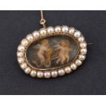 A VICTORIAN SEED PEARL AND CHERUB PICTURE BROOCH The oval brooch mounted in seed pearls and