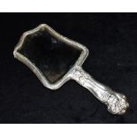 AN ORNATE SILVER HANDLED AND BACKED MIRROR with figural detail to handles, hallmarked for