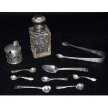 A COLLECTION OF SILVER To include a silver topped cut glass perfume bottle with glass stopper, a