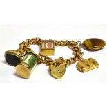 A 9CT GOLD CHARM BRACELET The charm comprising of a heart padlock curb link chain, safety chain