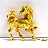 A 9CT GOLD PRACNING HORSE BROOCH AND SAFETY CHAIN Marked 9.375 Birmingham (faded date letter), maker