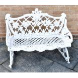 A SMALL COALBROOKDALE STYLE CAST METAL BENCH painted white, the back cast with leaves and berries on
