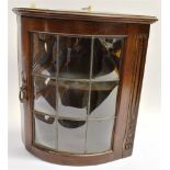 A PAIR OF MAHOGANY BOW FRONT HANGING CORNER CABINETS the lead glazed doors with nine panes of