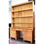 A LARGE VICTORIAN PINE AND PITCH PINE DRESSER the rack with boarded back and three shelves, the base