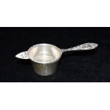 A SILVER TEA STRAINER AND SILVER HOLDER Both hallmarked for Sheffield 1973, tea strainer 16cm