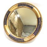 A CIRCULAR WALL MIRROR with bevelled glass, the frame with blue painted and gilt decoration, 38cm